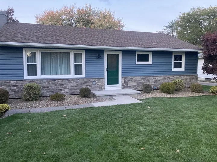 Finished blue siding and stone exterior